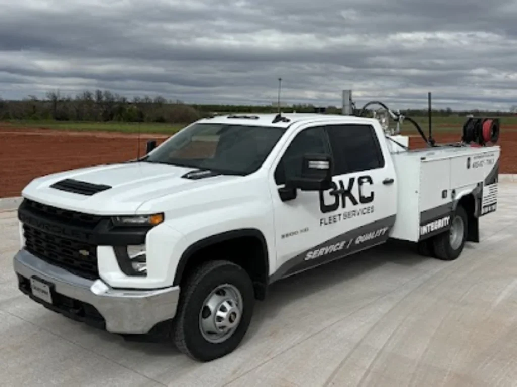 A white Chevrolet utility truck branded with OKC offers professional fleet services in edmond for commercial vehicle maintenance and repair.